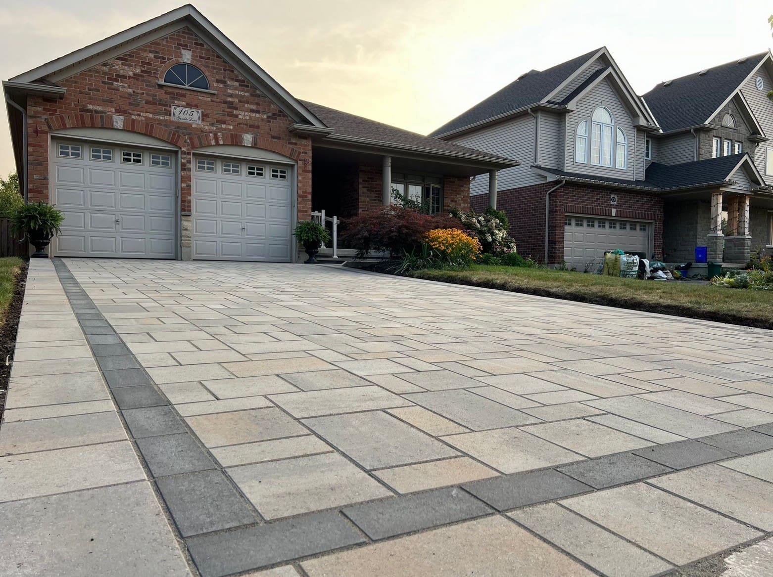 Professional installation of patio slabs in Hamilton showing compacted base preparation.
